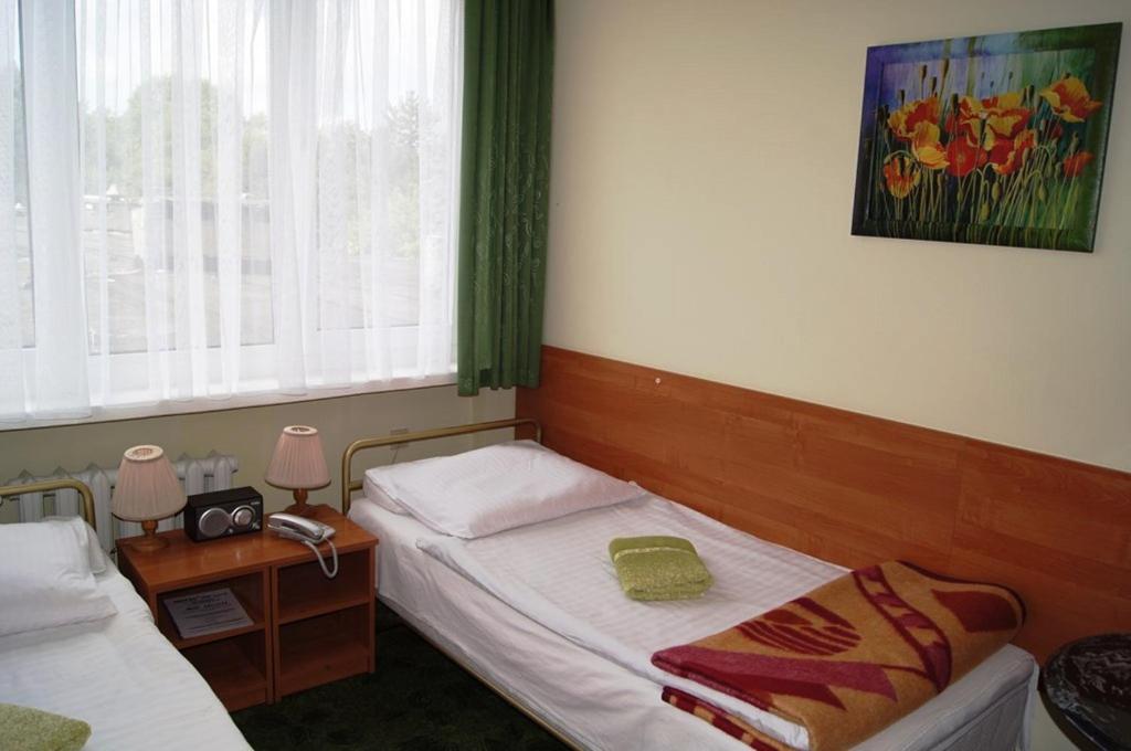 a small room with two beds and a window at HOTEL ODR in Sulechów