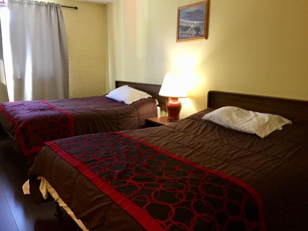 Postel nebo postele na pokoji v ubytování Villagers Inn
