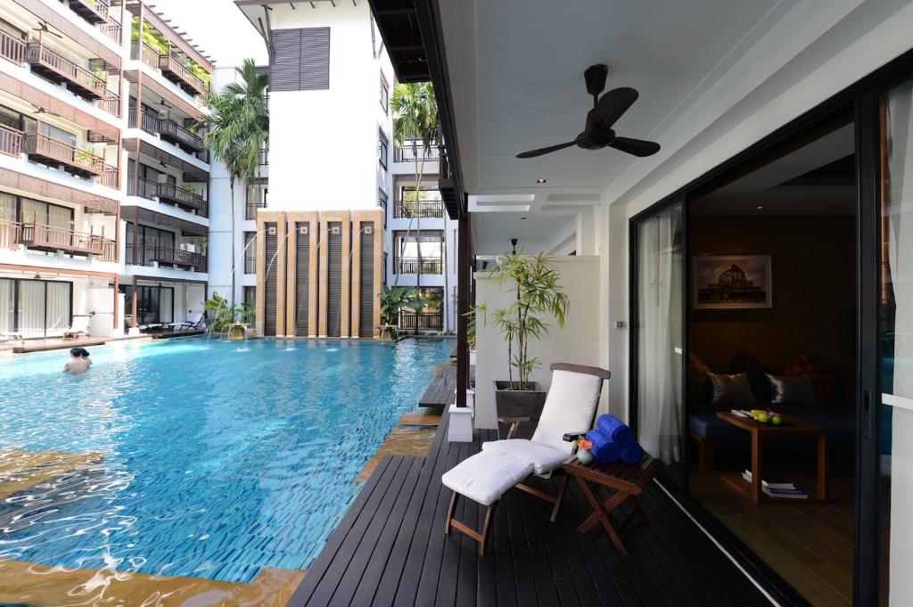 A poolside deck beside a ground-floor room or lounge.