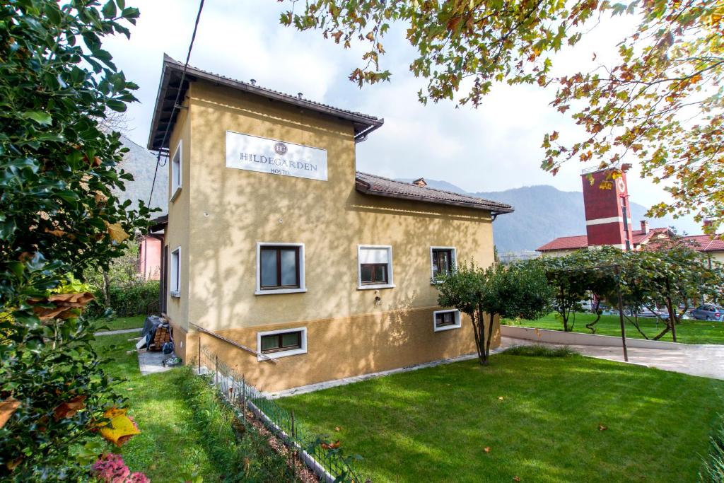 a large brick building with a large window at Hostel Hildegarden in Tolmin