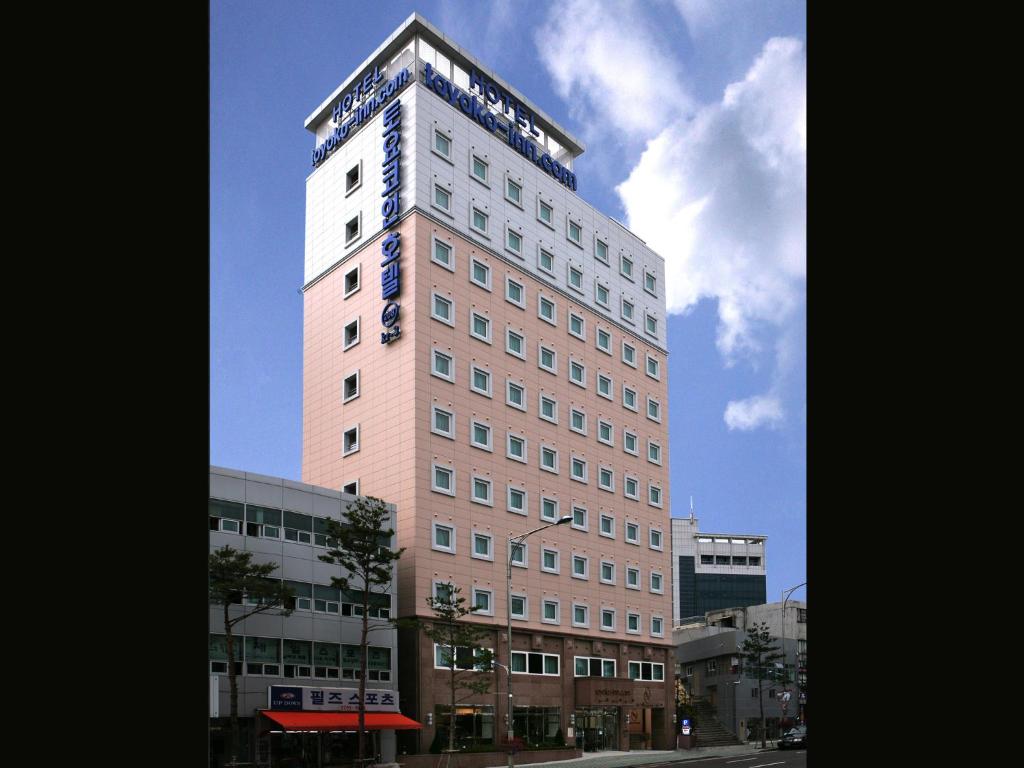 a tall building with a sign on top of it at Toyoko Inn Seoul Dongdaemun I in Seoul