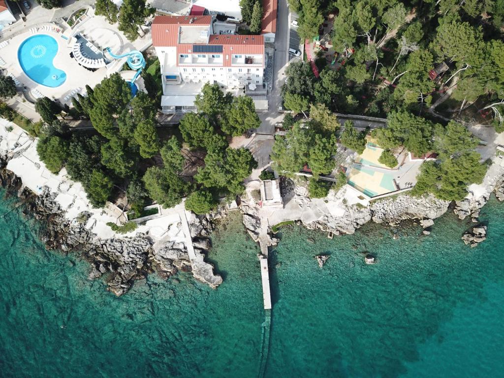 an aerial view of a resort and a pool in the water at Sesar Apartments Krk - No. 1 Iva in Krk