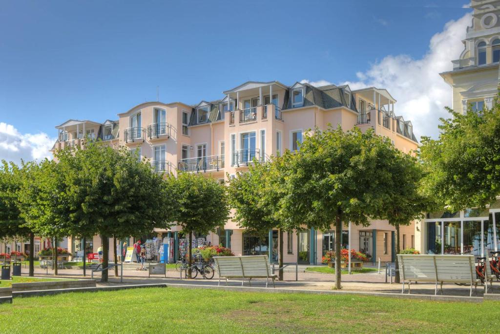 a large building with trees in front of it at SEETELHOTEL Ostseeresidenz Ahlbeck in Ahlbeck