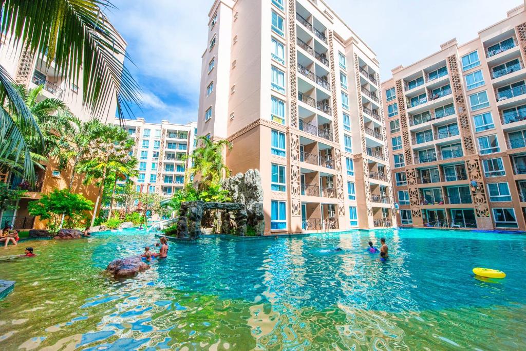 a swimming pool in the middle of a city with buildings at Atlantis Residence in Jomtien Beach