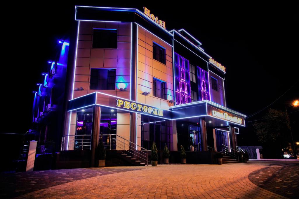 a building with purple and blue lights on it at Hotel Kremleff in Krasnodar