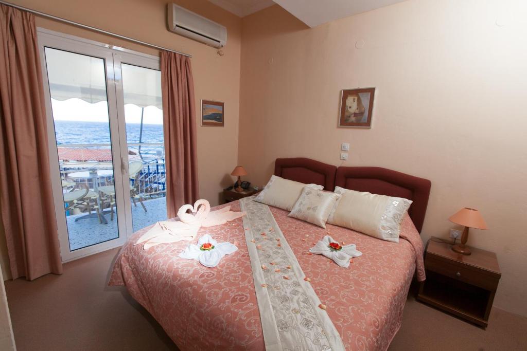 a bedroom with a bed with two towels on it at Acqua Marina - Άκουα Μαρίνα in Agia Marina Aegina