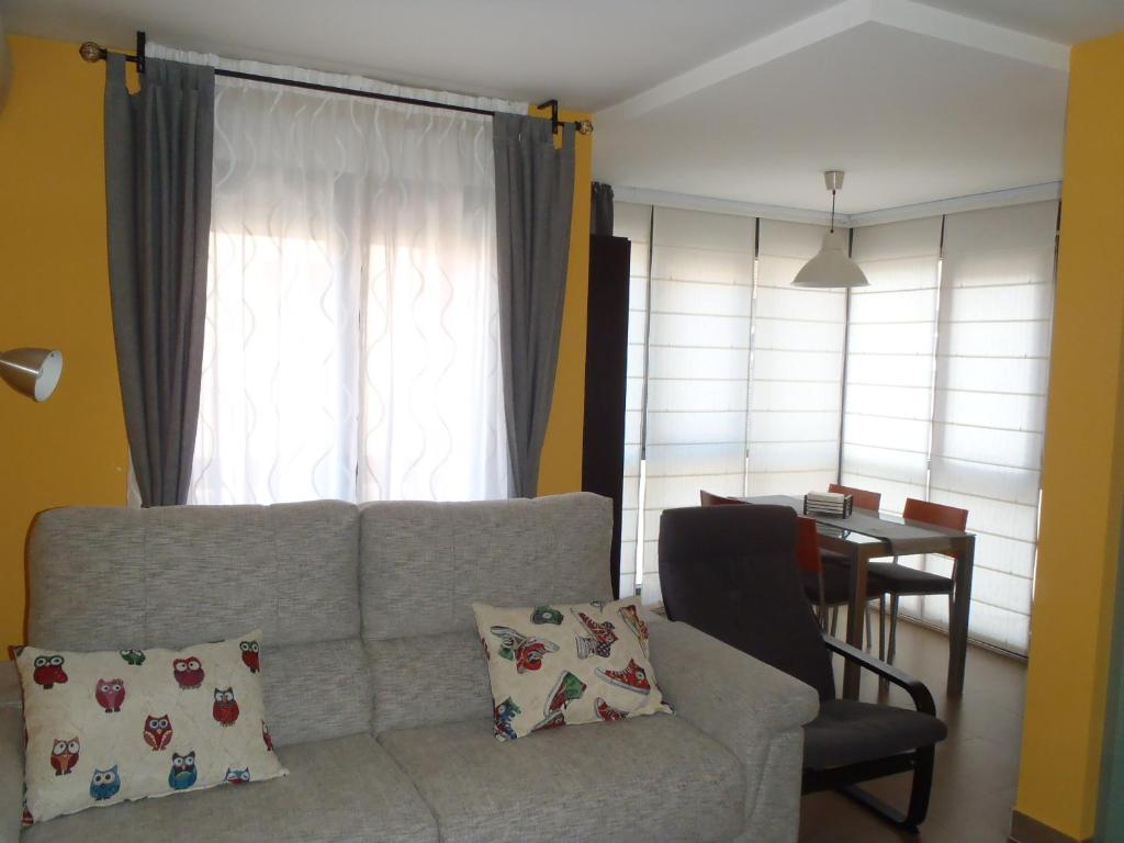 a living room with a couch and a table at El Balconcito de San Millan II in Segovia