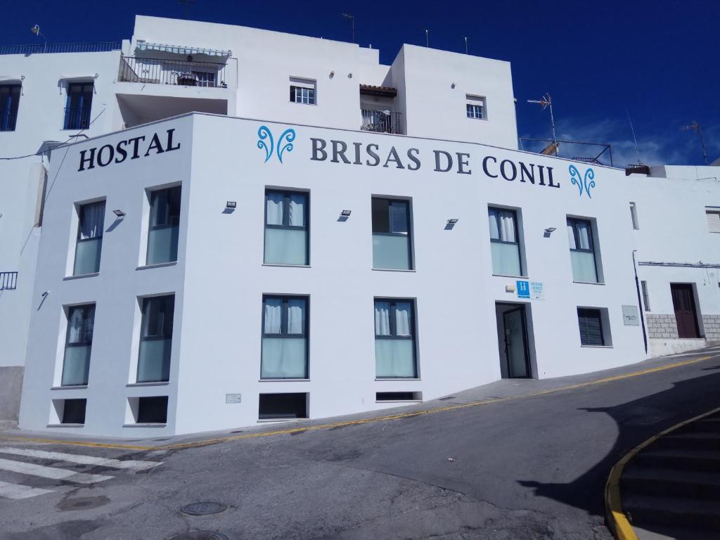 a white building with the words hostel brissas de council at Hostal Brisas de Conil in Conil de la Frontera