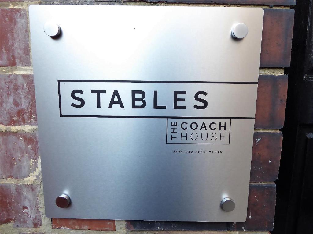 a metal box on the side of a brick wall at Stables at The Coach House Apartments in Leeds