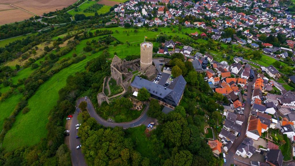 an aerial view of a small town with a clock tower at Talblick Gleiberg in Krofdorf-Gleiberg