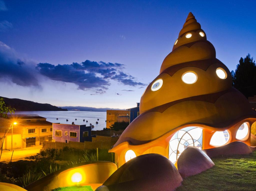 a night view of a building with lights on it at Hostal Las Olas in Copacabana