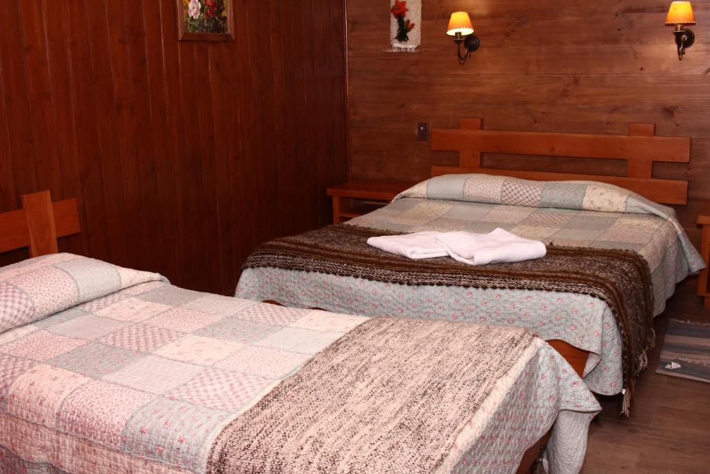 Postel nebo postele na pokoji v ubytování Hostal el Nogal Pucón