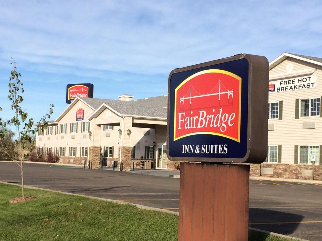 a sign for a fair bridge inn and suites at Fairbridge Inn and Suites - Miles City in Miles City