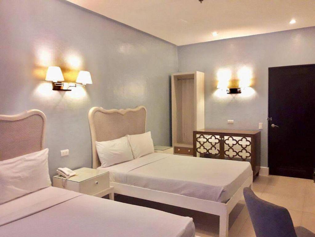 Voodi või voodid majutusasutuse Hotel Lorenza toas