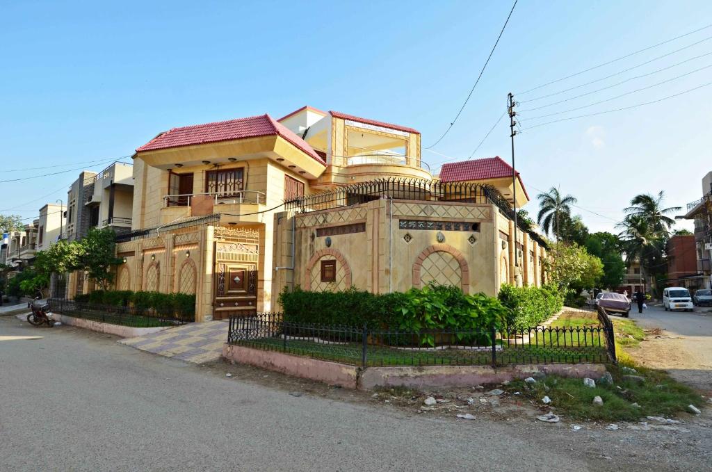 an old house on the side of a street at Hotel Blue Sky Executive in Karachi