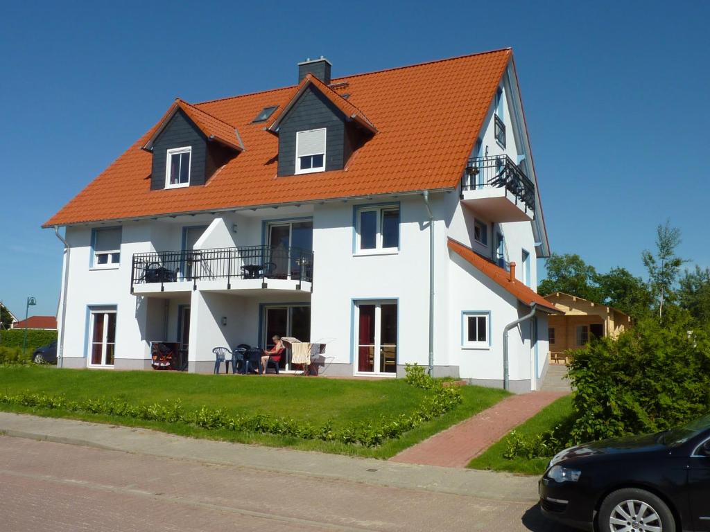 a large white house with an orange roof at Ferienhaus NEMO in Rerik