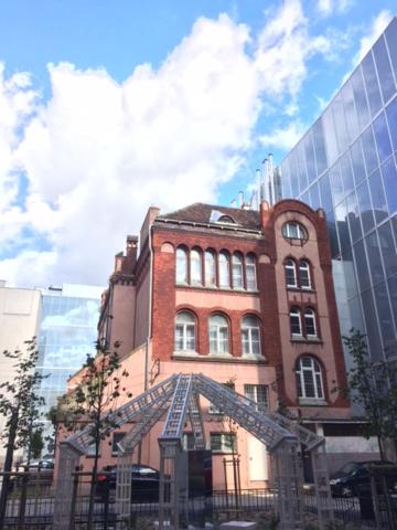 a tall brick building with a ladder in front at U Szermierzy in Wrocław