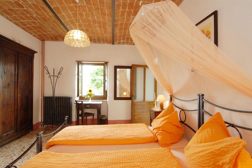Postel nebo postele na pokoji v ubytování Agriturismo Sondrea