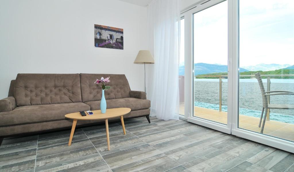 a living room with a couch and a table at Apartments Edera in Tivat