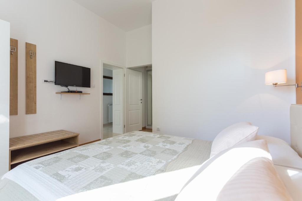 Posteľ alebo postele v izbe v ubytovaní Apartments Villa Victoria