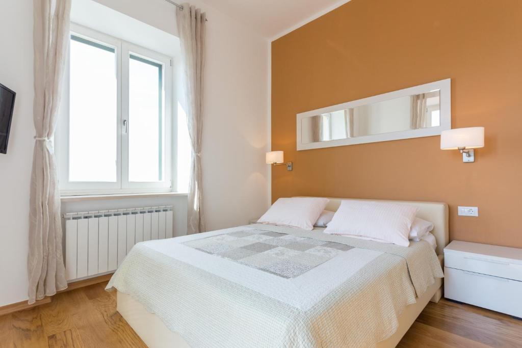 Posteľ alebo postele v izbe v ubytovaní Apartments Villa Victoria