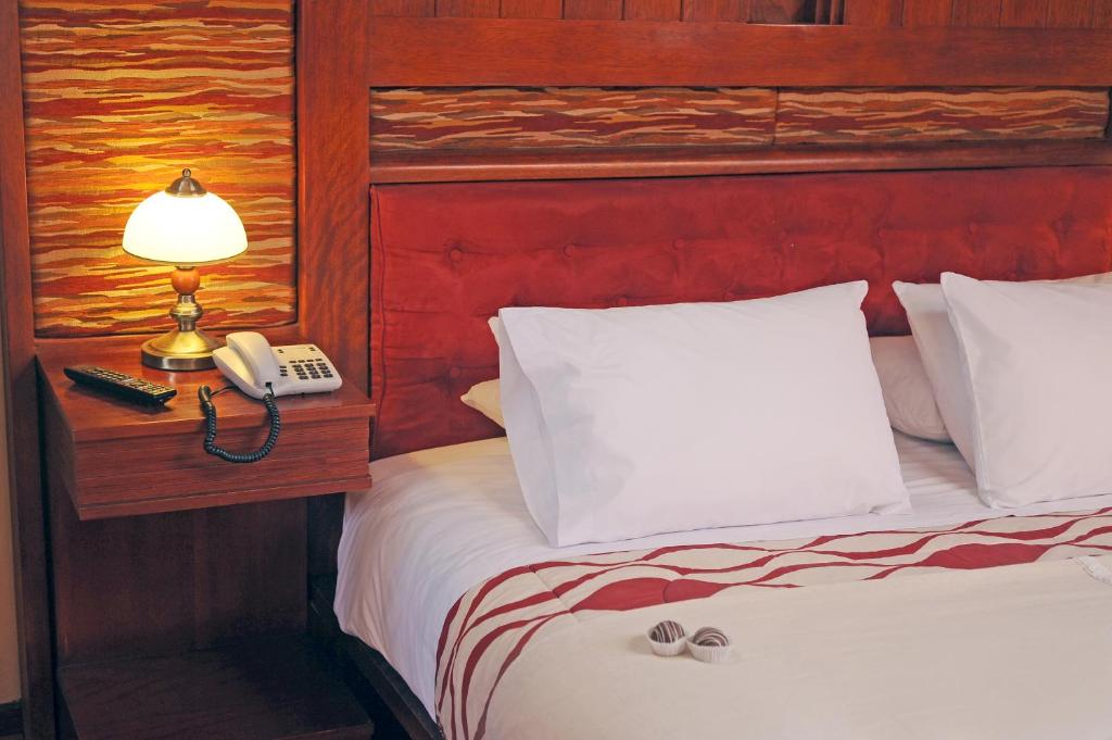 Postel nebo postele na pokoji v ubytování Hotel Waynapicchu