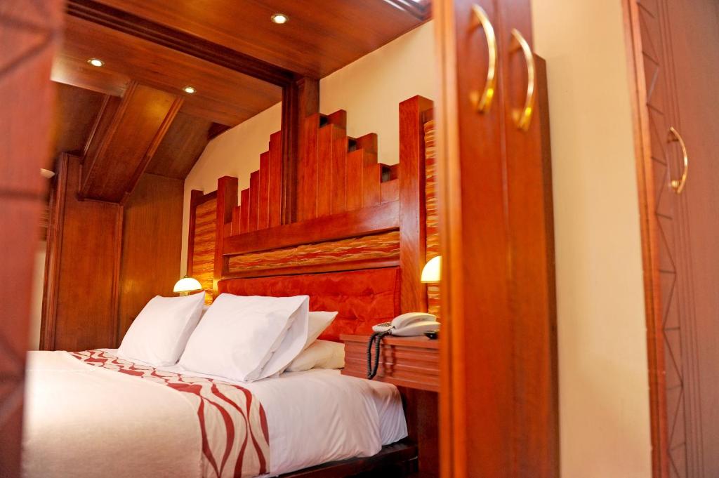 Postel nebo postele na pokoji v ubytování Hotel Waynapicchu
