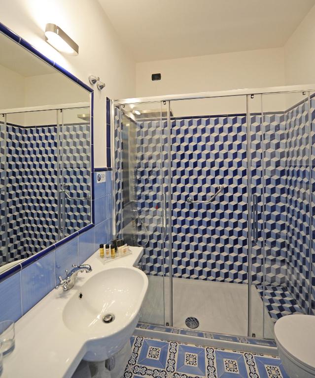 a bathroom with a toilet and a sink and a shower at Hotel Aurora in Amalfi