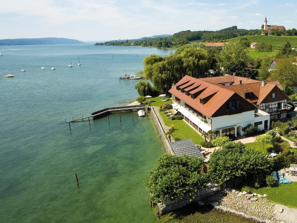 an aerial view of a house on the water at Hotel Restaurant Seehalde in Uhldingen-Mühlhofen