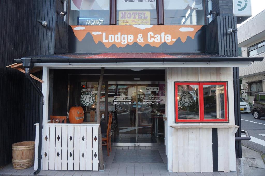 ein Gebäude mit einem Schild für eine Lodge und ein Café in der Unterkunft Nikko Park Lodge Tobu Station in Nikko