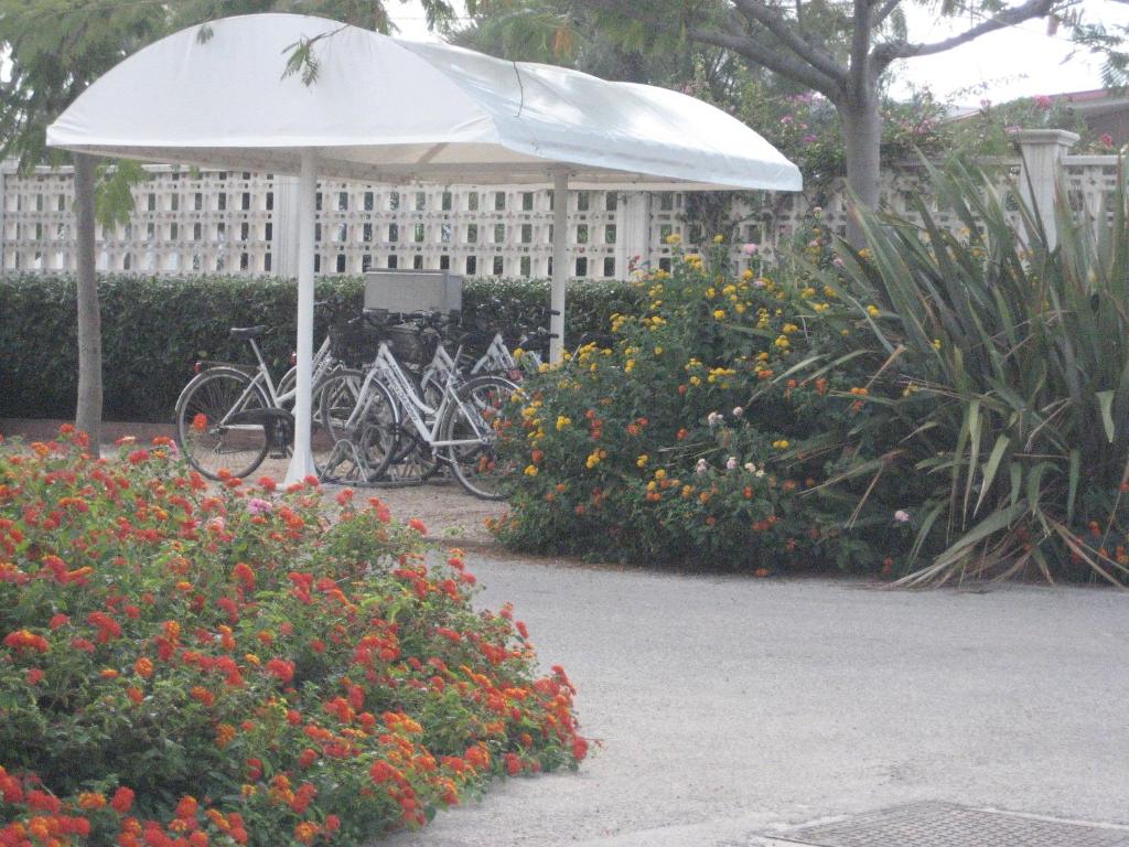 a group of bikes parked under a white umbrella at Residence Club Barbara in Ostuni