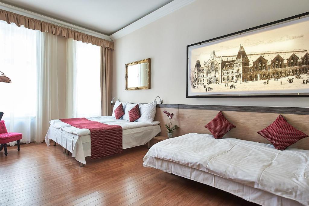 Postel nebo postele na pokoji v ubytování Lion Prémium Hotel
