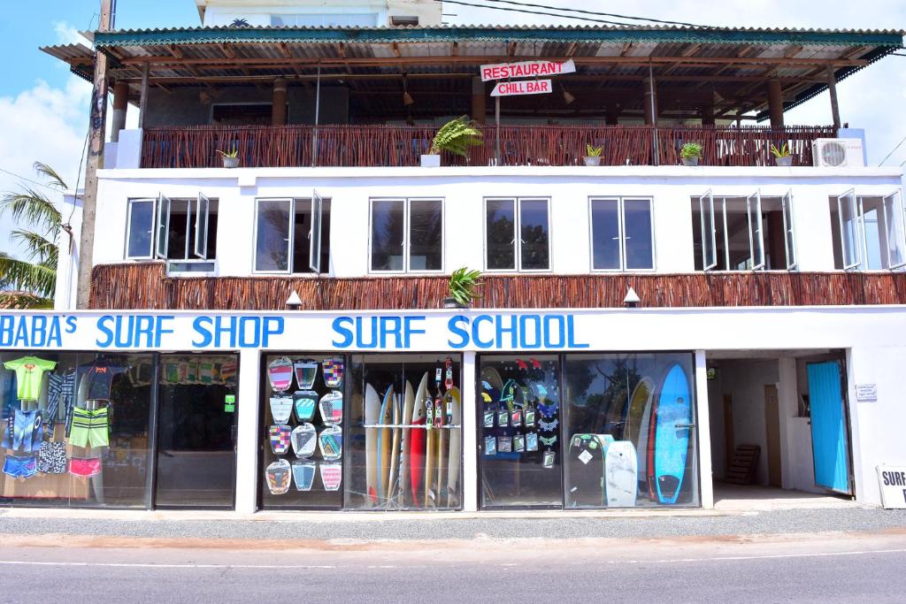 
a store front with a large window at Cheeky Monkey Surf Camp in Weligama
