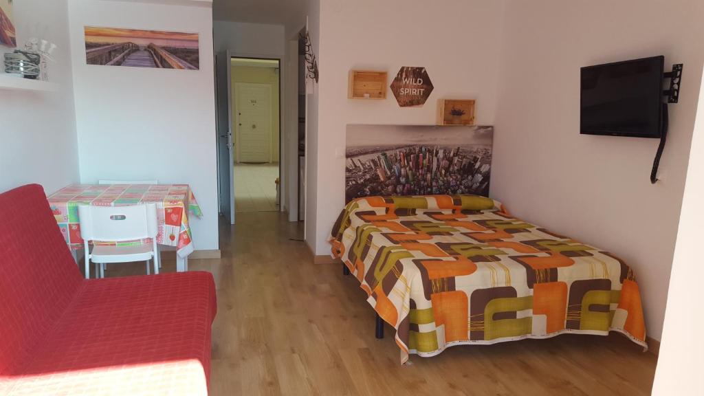 a bedroom with a bed and a table with a chair at jp - 2.0 in Benalmádena