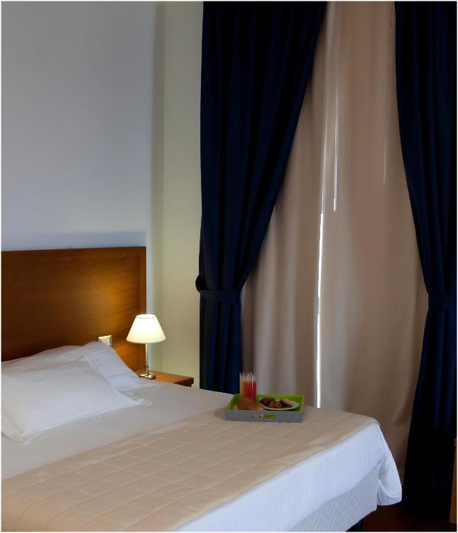Łóżko lub łóżka w pokoju w obiekcie Hotel Tiziano