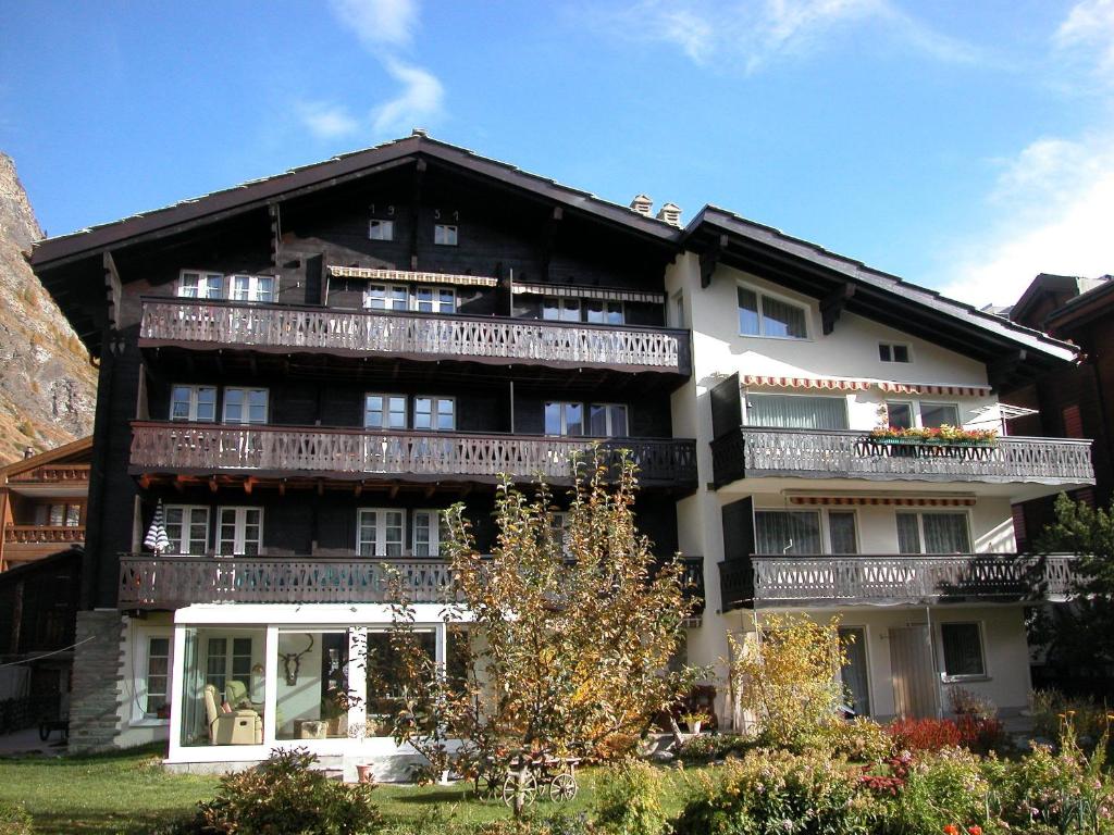 a large building with balconies on the side of it at Chalet Bergkristall in Zermatt