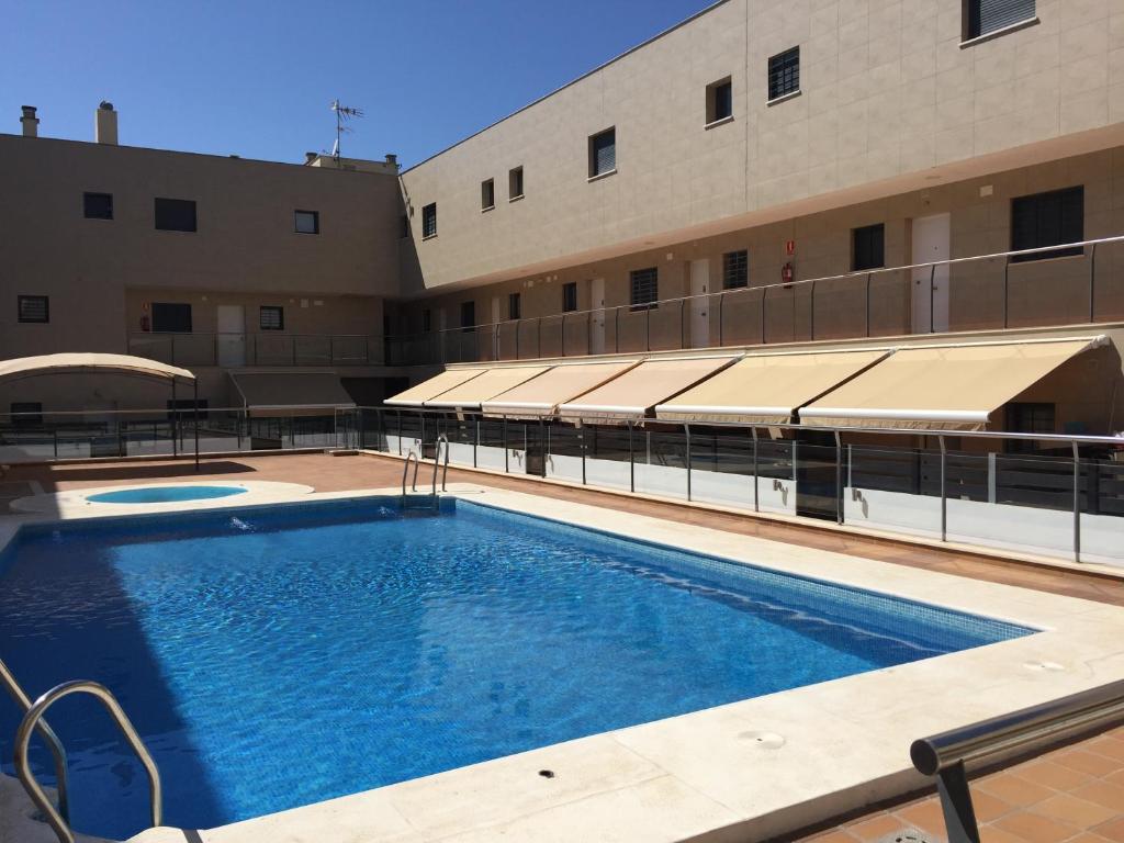 uma piscina em frente a um edifício em Punta Umbría Playa Ria em Punta Umbría