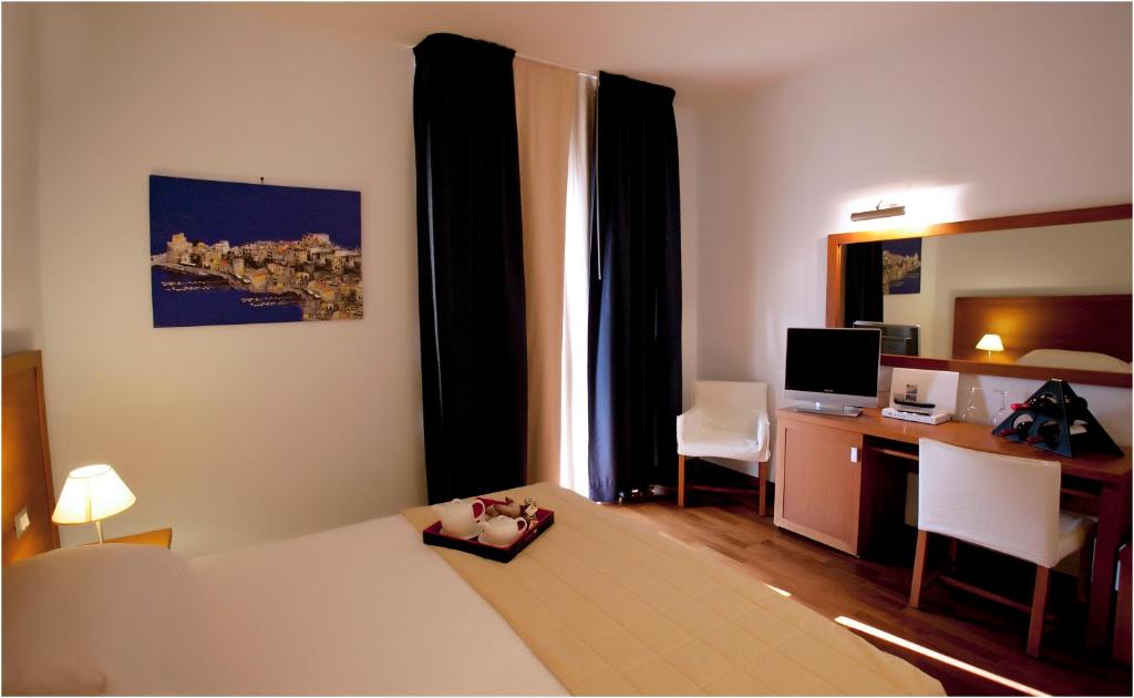 Łóżko lub łóżka w pokoju w obiekcie Hotel Tiziano
