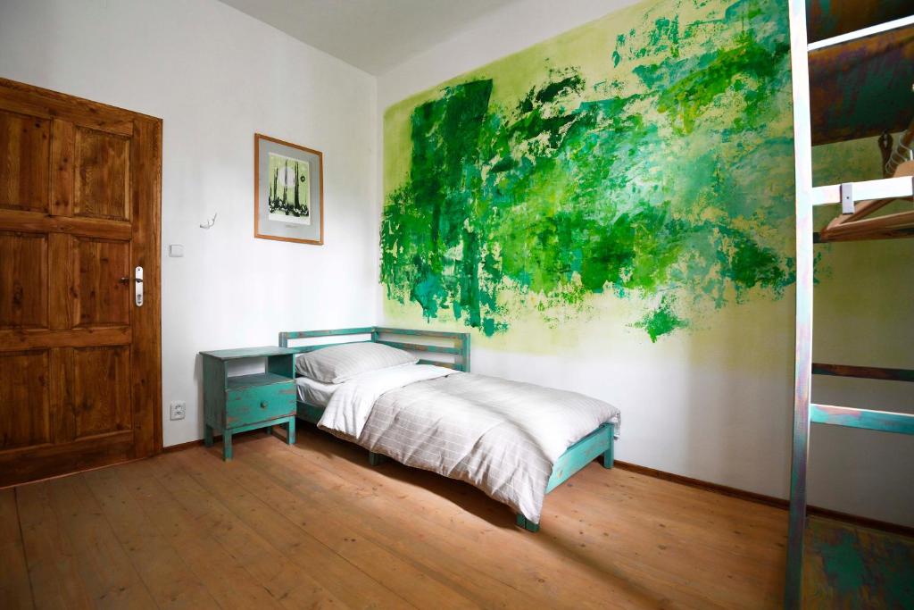a bedroom with a bed and a desk and a painting at Giotto Apartments in Prague