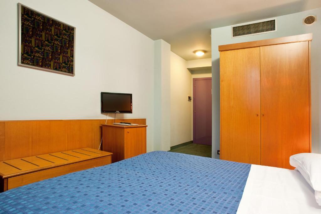 Llit o llits en una habitació de Hotel Gardenia