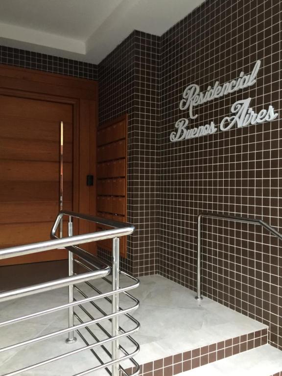 a staircase in a building with a sign on the wall at Buenos Aires 605 in Osório