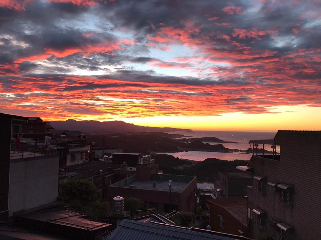 a view of a city with a sunset at Jiufen Ligin B&B in Jiufen