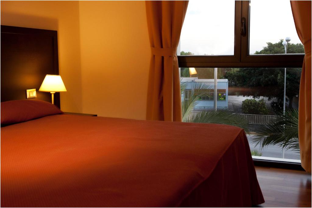 Łóżko lub łóżka w pokoju w obiekcie Hotel Tiziano