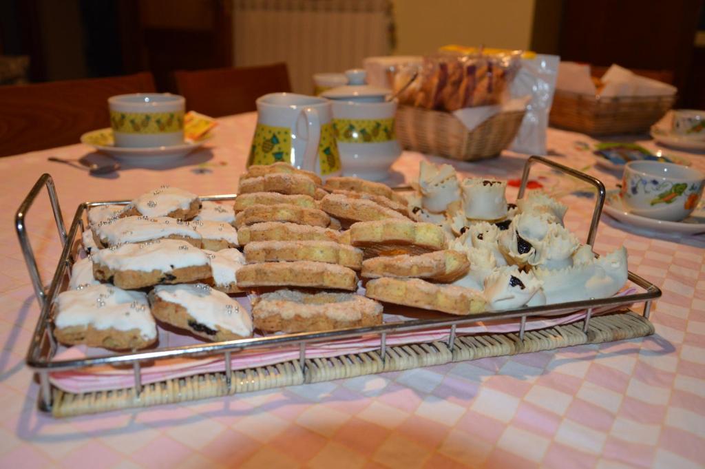 a tray of pastries and other desserts on a table at Sa Domo Tua IUN E5942 in Bonorva