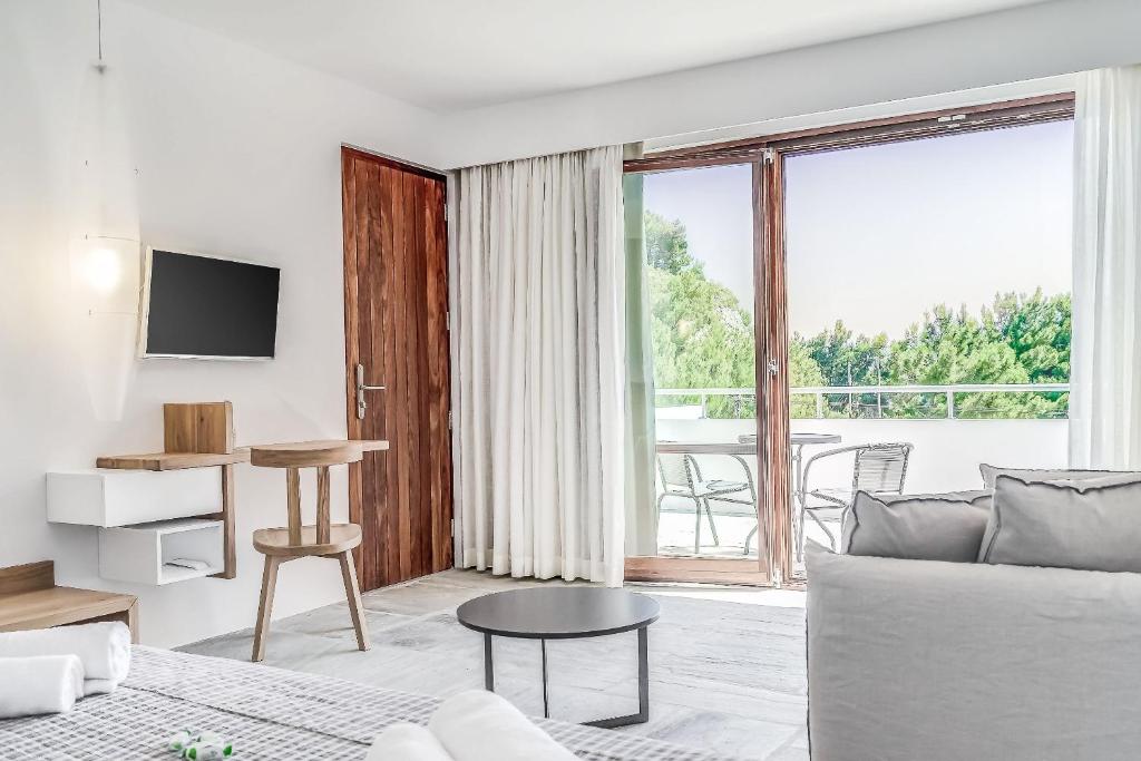 a living room with a couch and a large window at Semeli in Kokkari