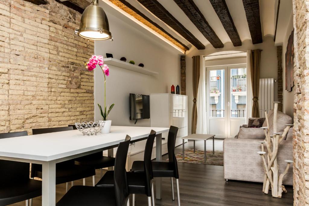 a dining room and living room with a white table and chairs at Welcoming Apart Old Town in Pamplona