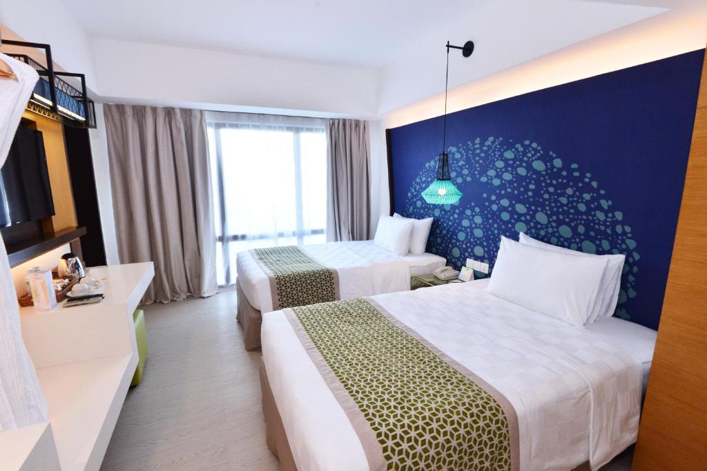 Uma cama ou camas num quarto em Hue Hotels and Resorts Boracay Managed by HII