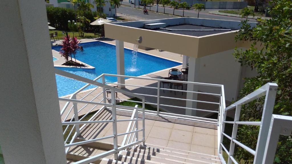 a view of a swimming pool from the balcony of a building at Flat 123 Bella Lunna in Guarajuba