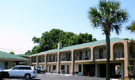 a building with a palm tree in front of it at Americas Best Value Inn-Savannah in Savannah