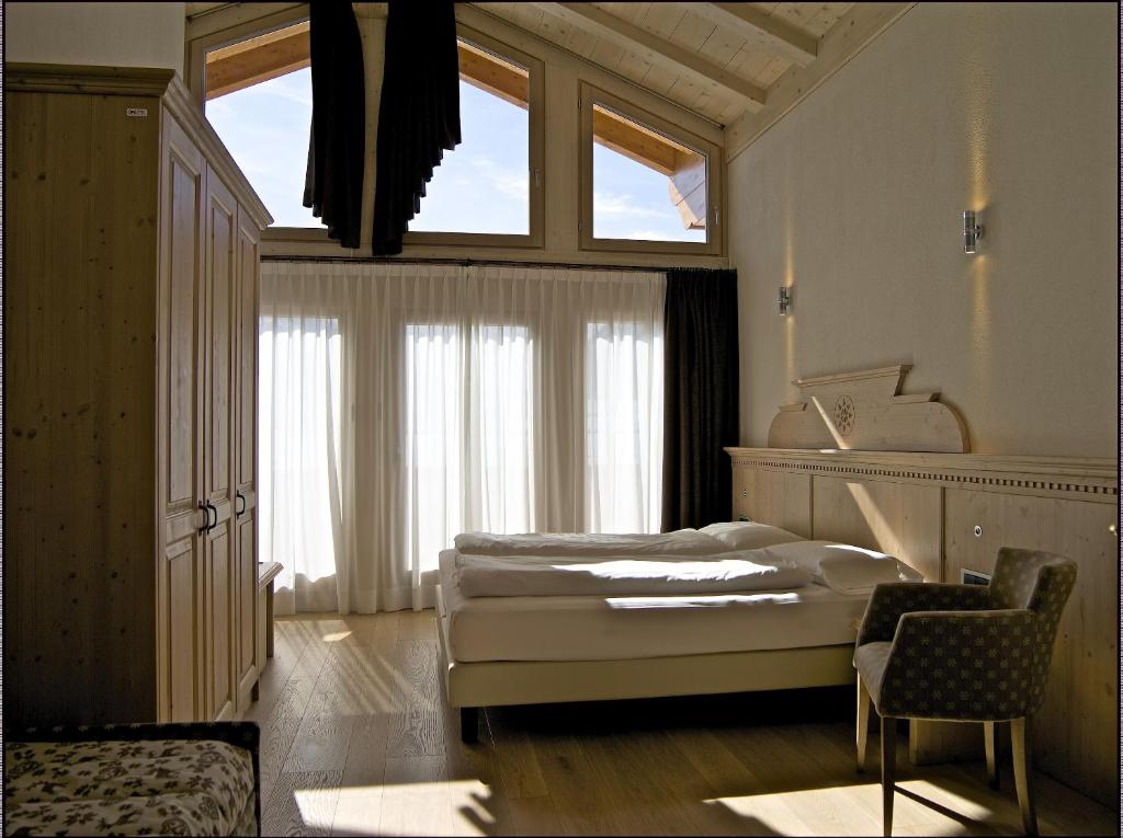 A bed or beds in a room at Hotel Alba